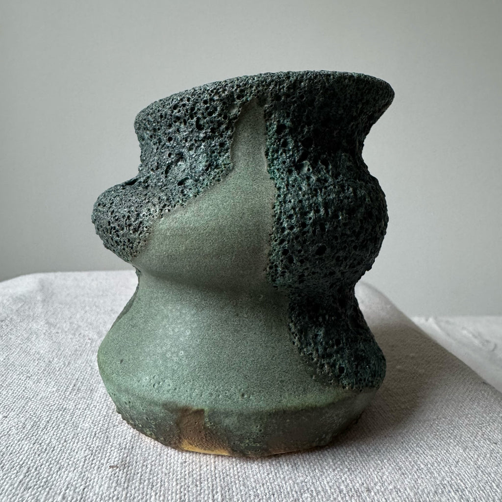 Ceramic vase with textured design on a white surface