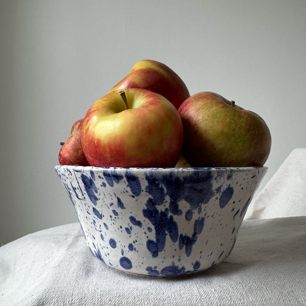 Bowl with apples on a light surface