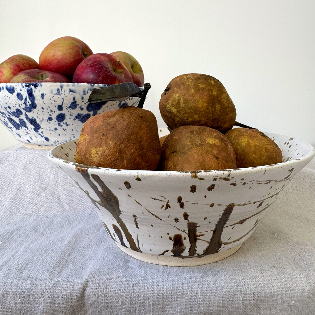 Bowl with pears and apples on a light fabric background