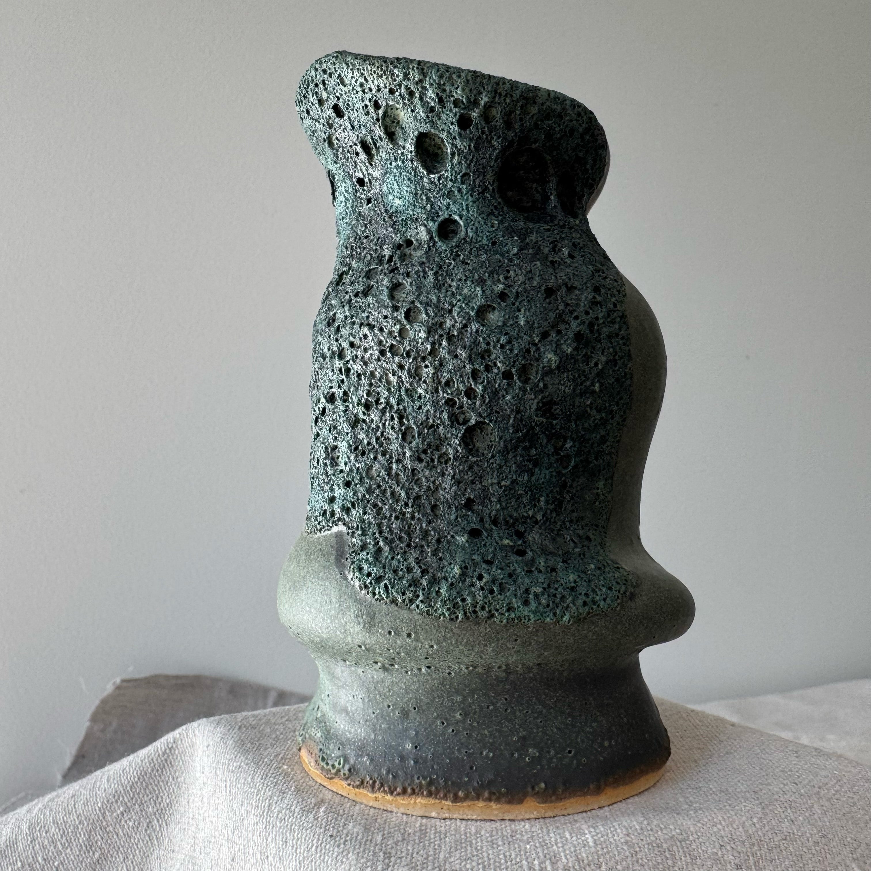 Textured ceramic vase on a neutral background