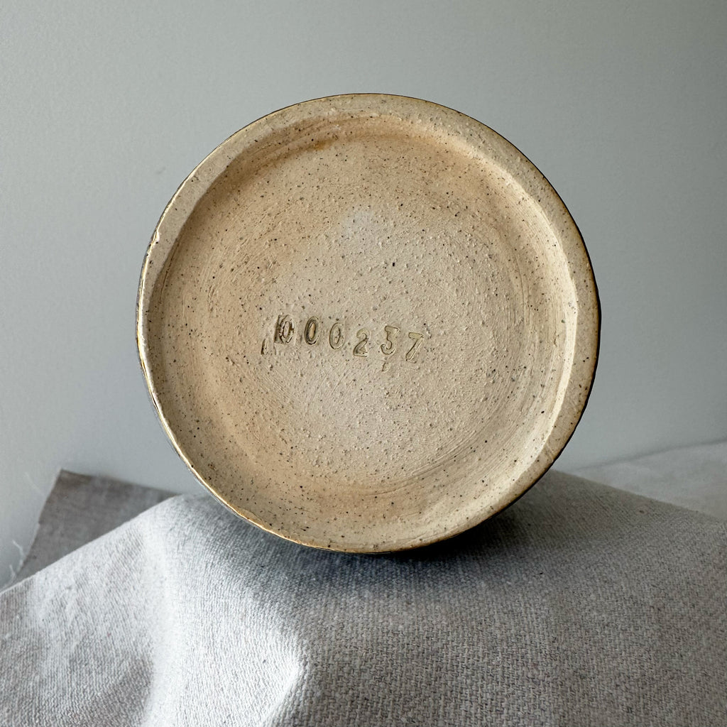 Ceramic plate with a textured surface on a gray fabric background