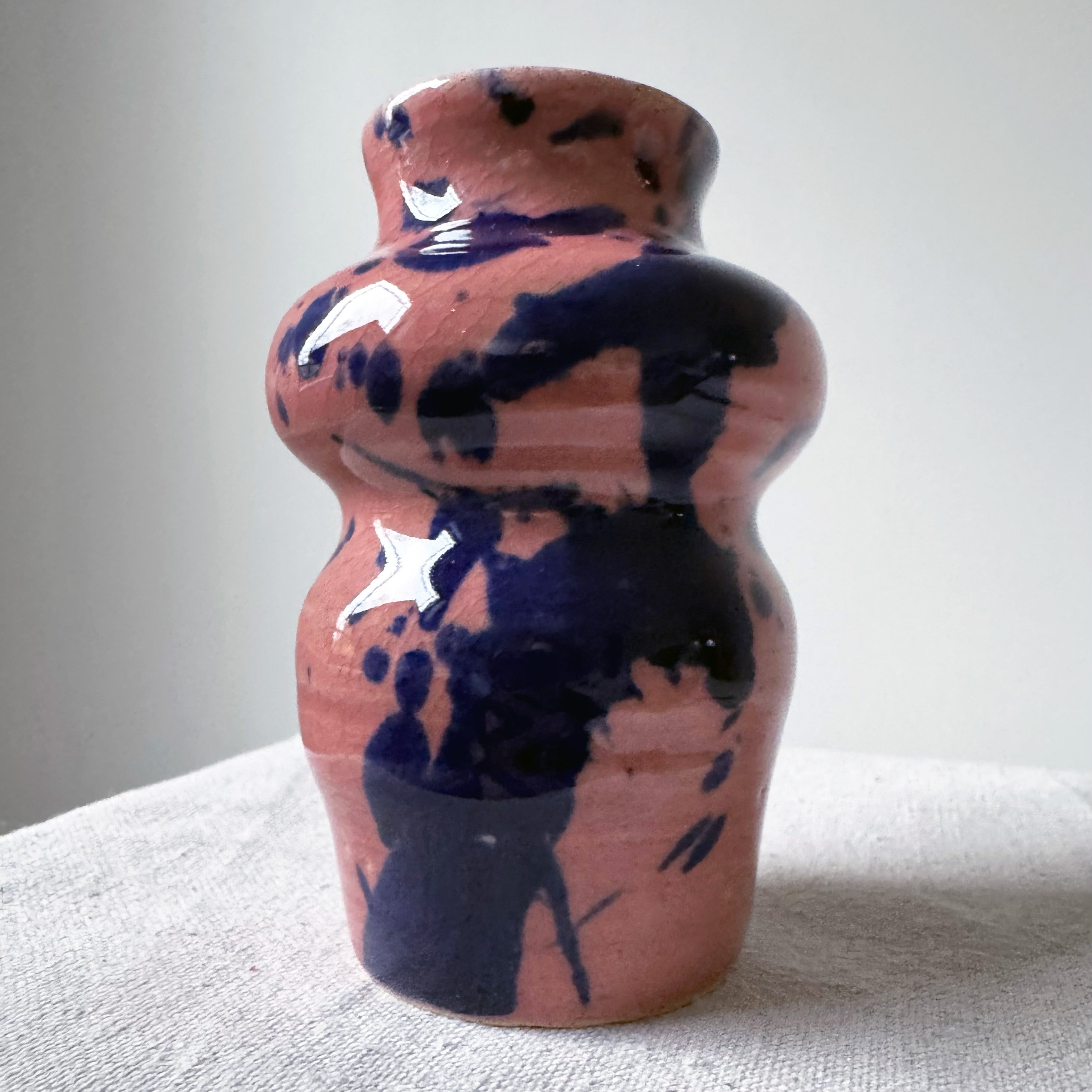 ceramic vase with pink glaze and blue splashes