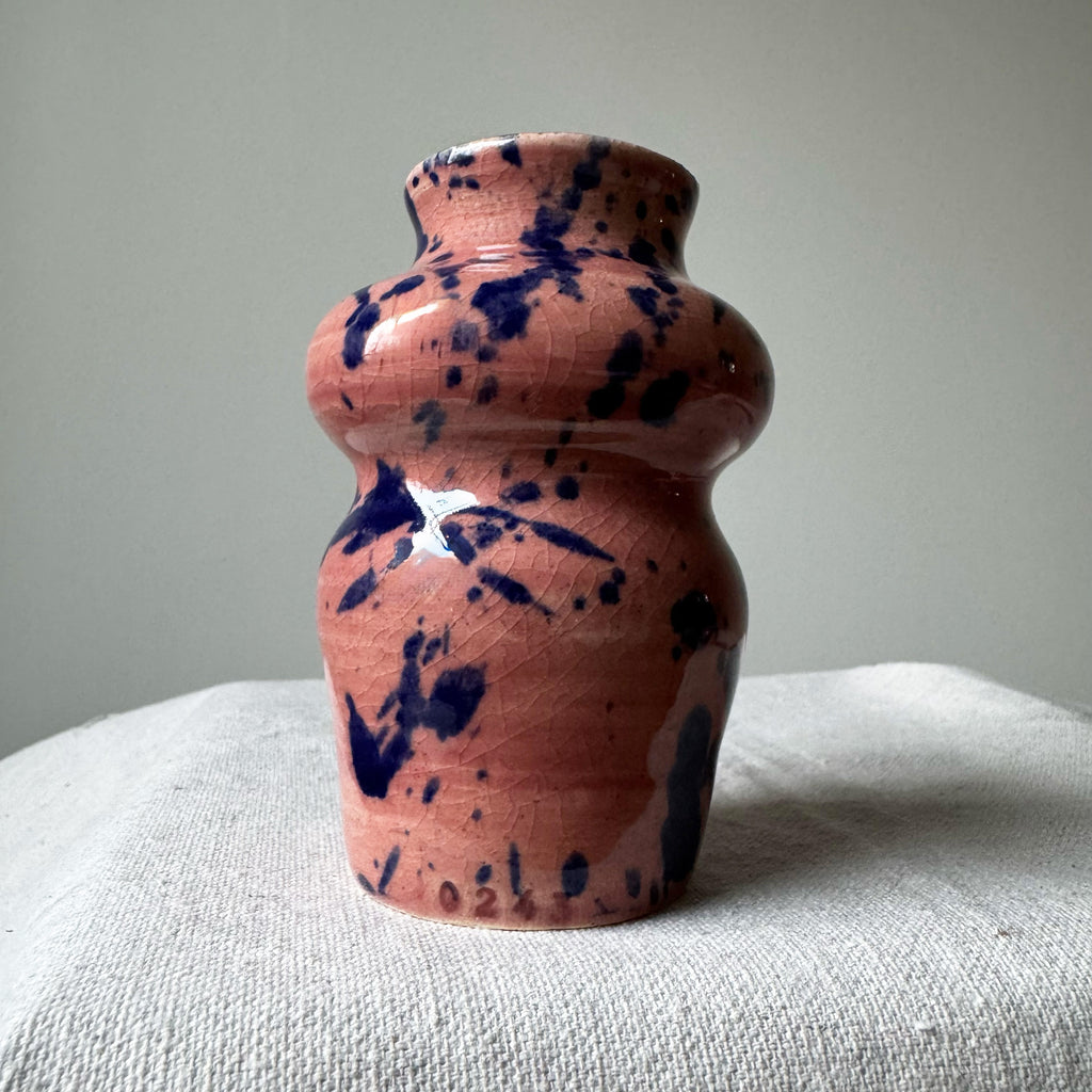 ceramic vase with pink glaze and blue splashes