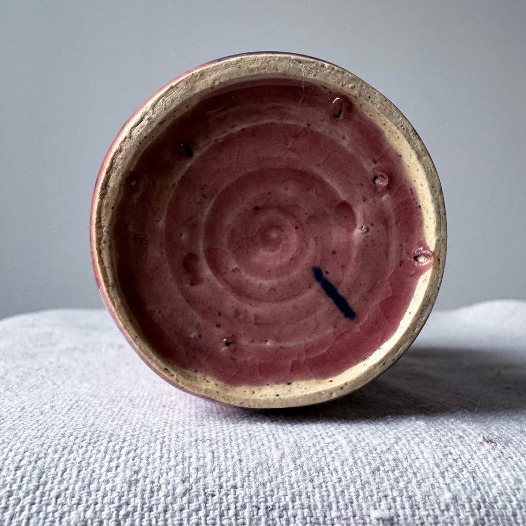 ceramic vase with pink glaze and blue splashes