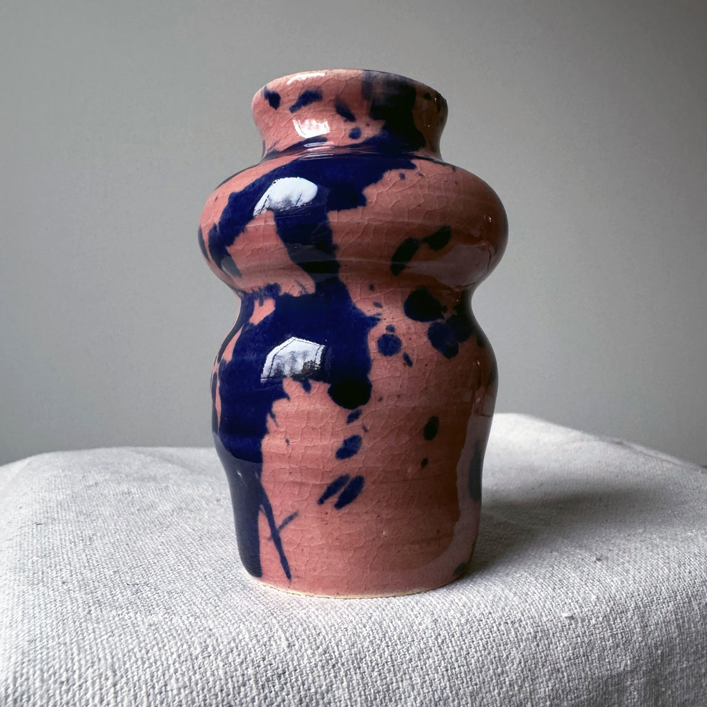 ceramic vase with pink glaze and blue splashes