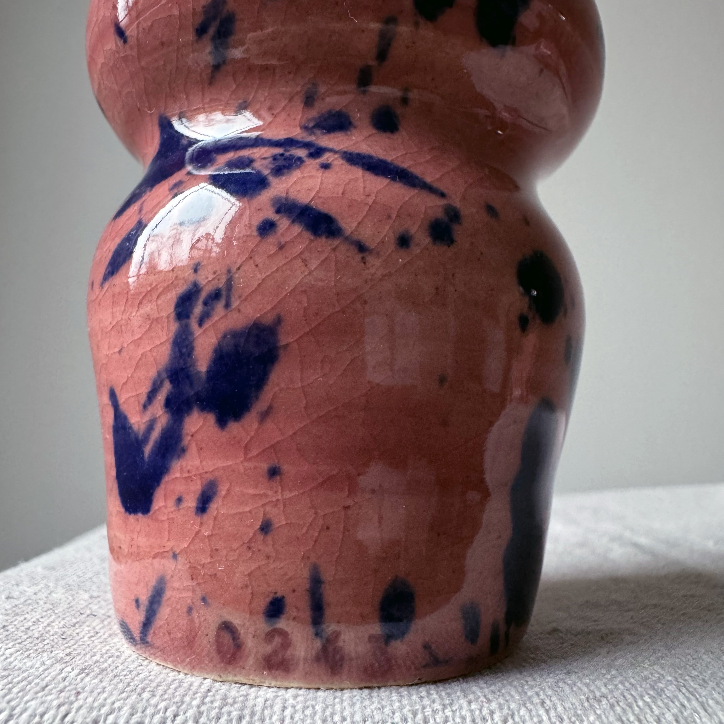ceramic vase with pink glaze and blue splashes
